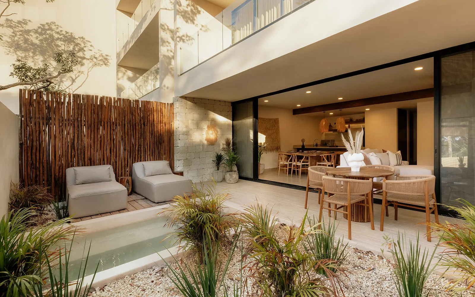 Indoor-outdoor living space with plunge pool and dining area in Tulum vacation rental