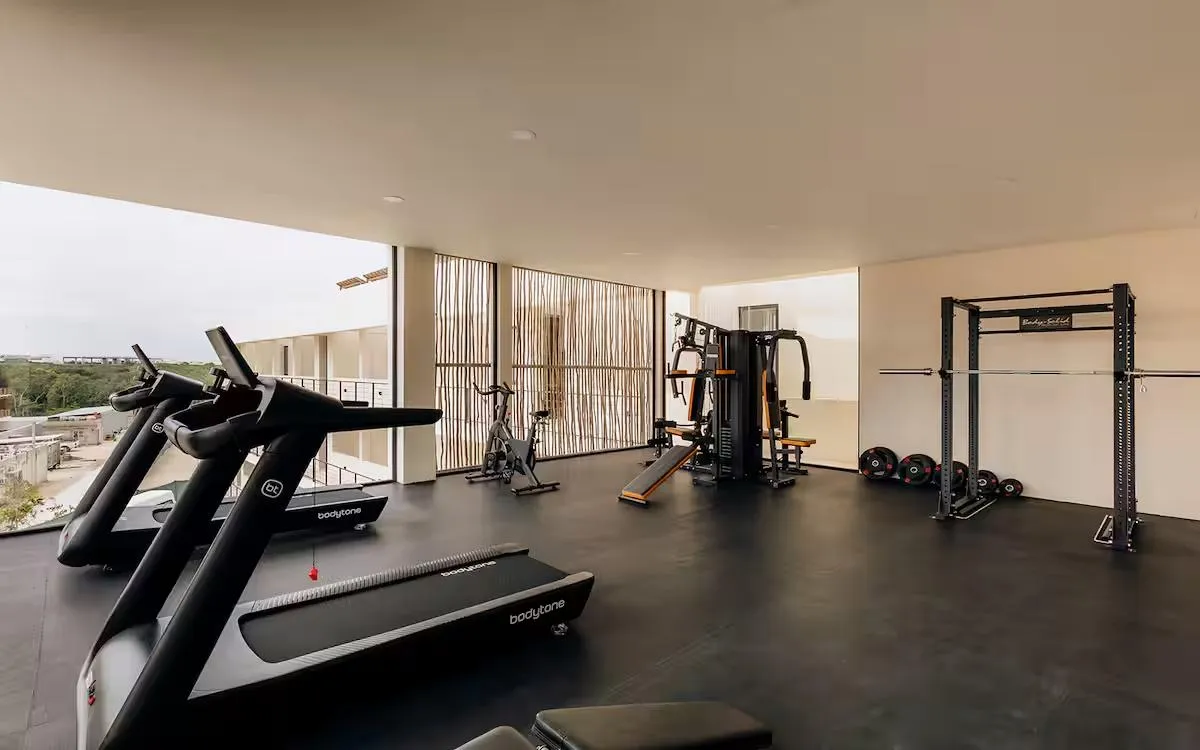 Fully equipped fitness center with jungle views at Samsara Tulum
