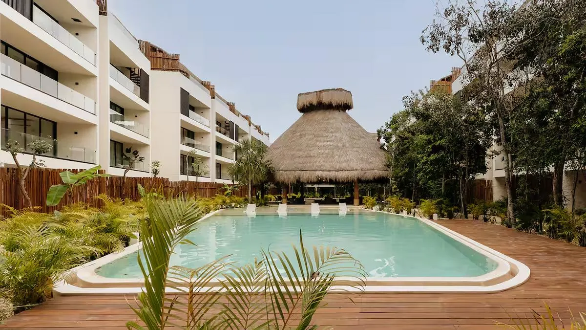 Common pool with palapa and tropical landscaping at Samsara Tulum